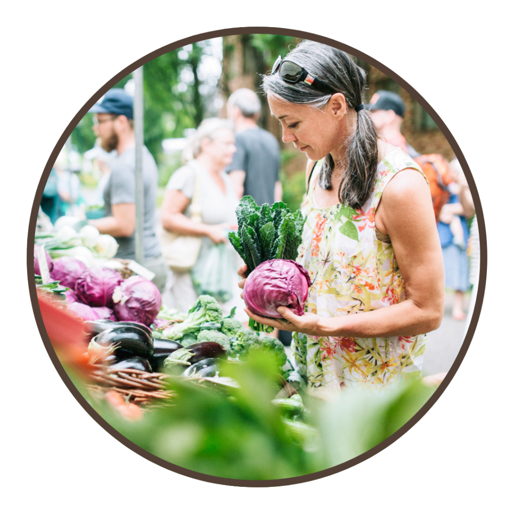 A woman shops for vegetables at the farmers market.