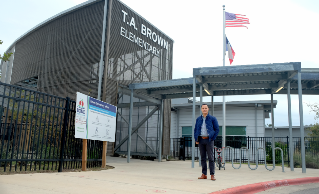 Andrew stands outside the entrance to T.A. Brown Elementary.