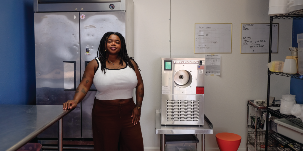 Chi stands in the kitchen, next to her ice cream machine, Emery, that makes all of Luv Fats' ice cream.
