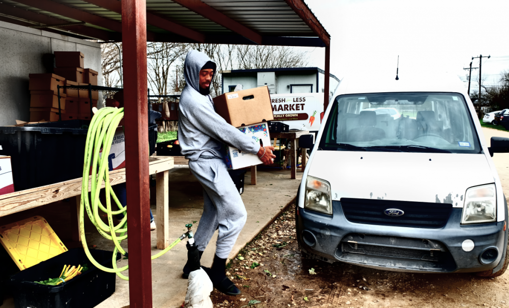 Chivas at Farmshare Austin collecting boxes of produce.