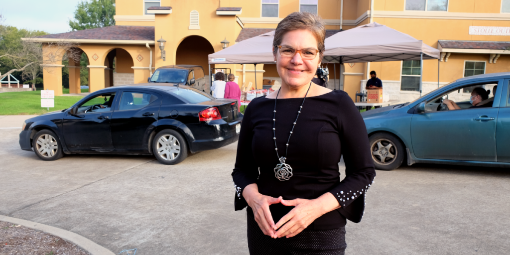 Dr. Murillo in front of a food distribution line at El Buen Samaritano.