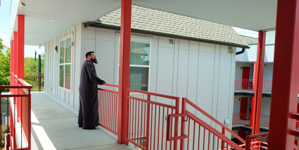 Jason Haskins looks out into the courtyard of the Roosevelt Gardens building.