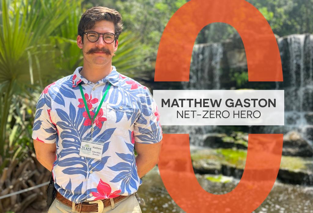 Matthew Gaston stands in front on palms and a waterfall in the Hartman Prehistoric Garden.