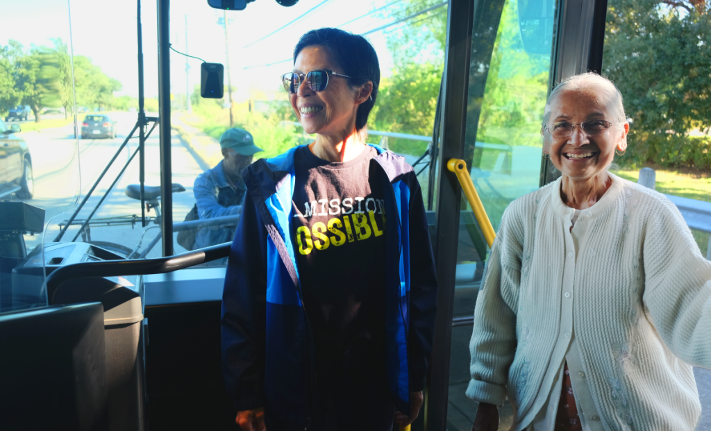 Niki and Himadri board the bus with big smiles.