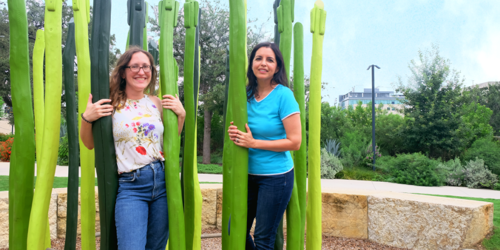 Lizette and Eileen stand amongst a sculpture of tall grasses at Waterloo Park.