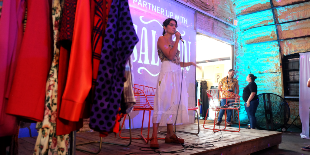 Reza speaks on stage at the Slow Fashion Festival.