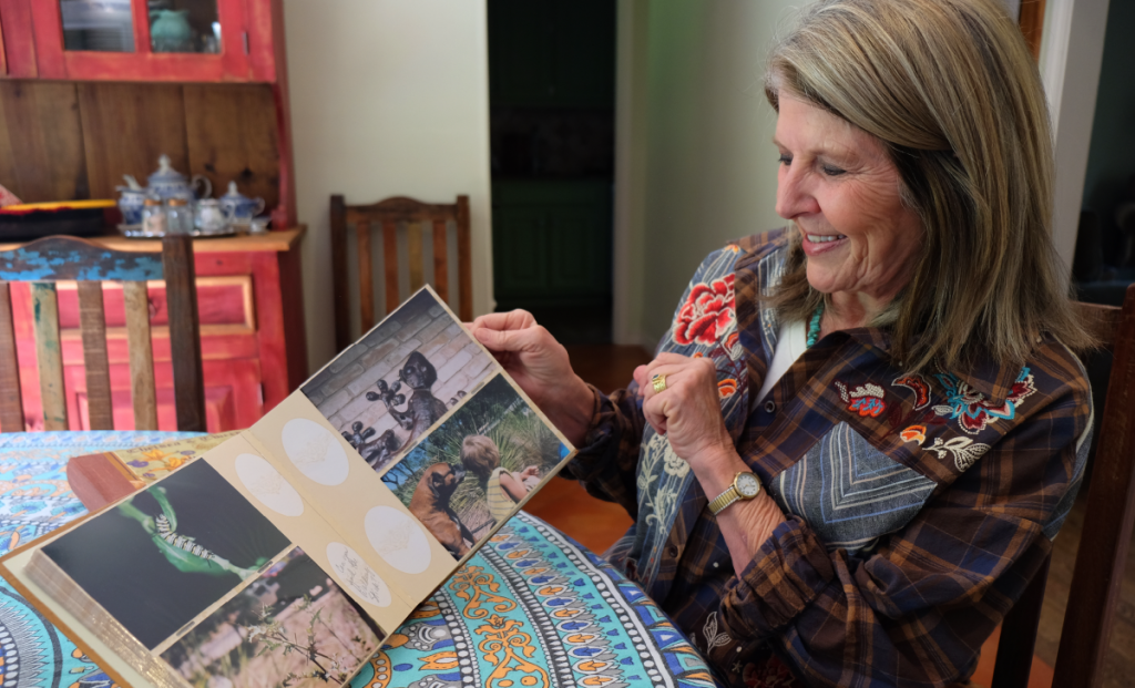 Susan smiles as she flips through a photo album of her garden renovation.