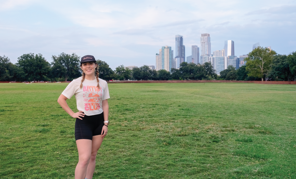 Thira poses at Zilker Park with Downtown Austin in the background.