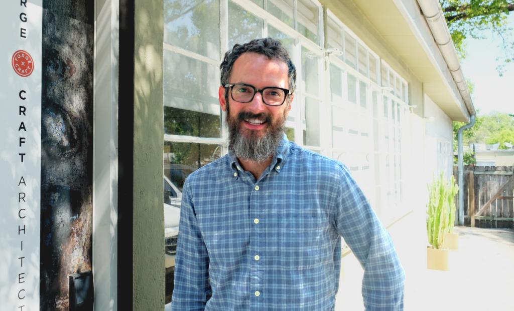 Trey smiles outside of Forge Craft Architecture & Design.