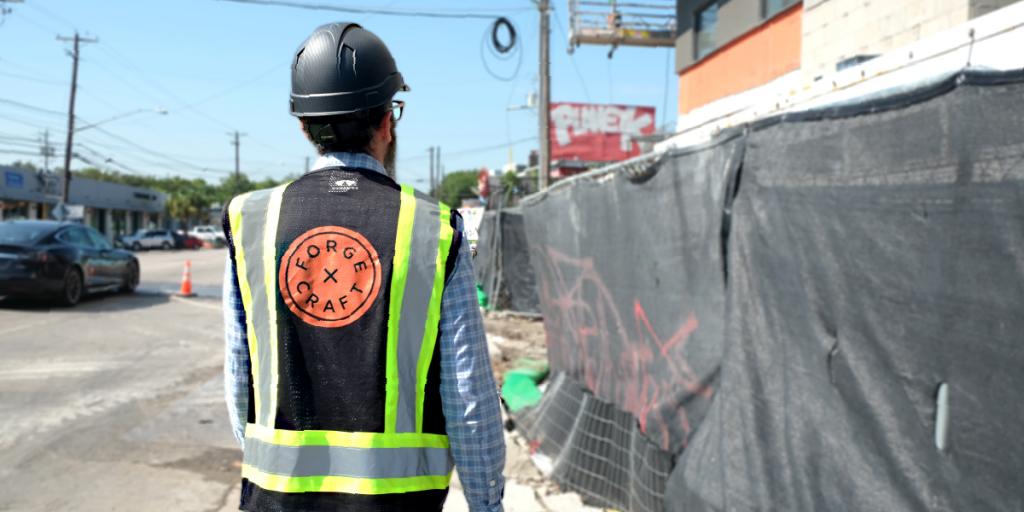 Trey walks down South Lamar to a construction project.