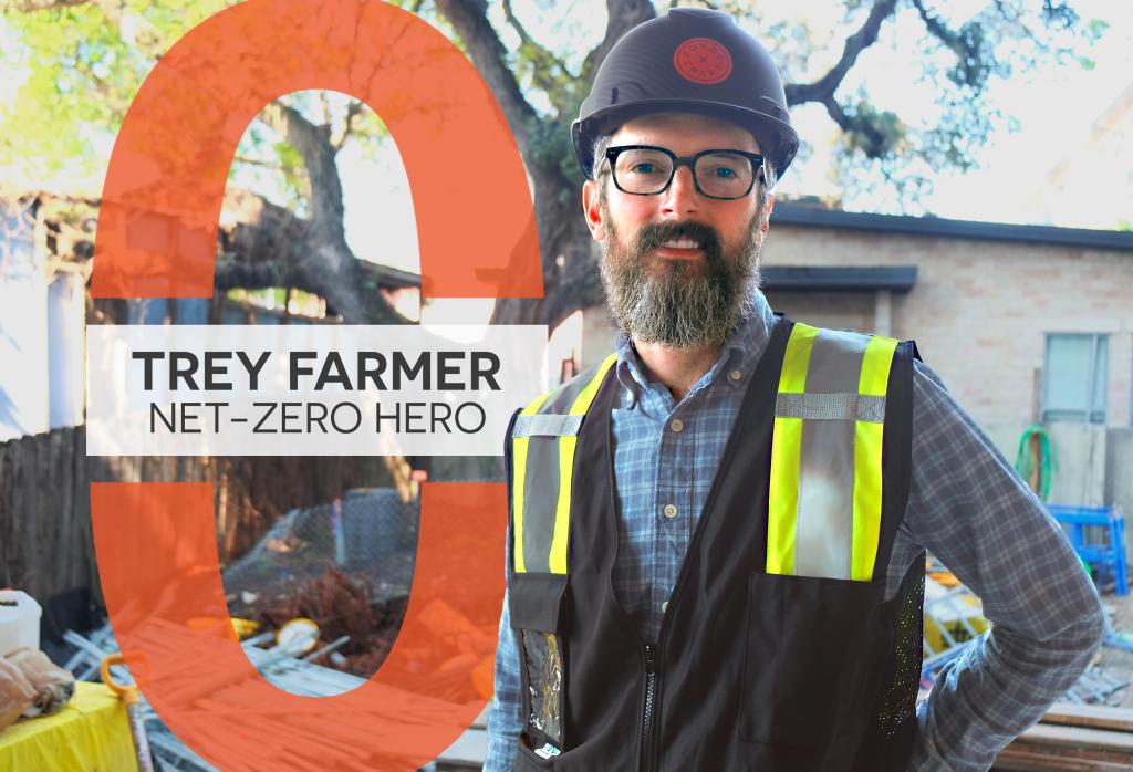 Trey stands at a construction project with a hard hat on.