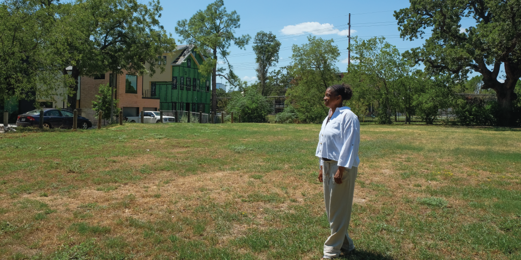 Warinda stands in the pocket park of CTI’s most recent project.
