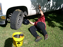 Slide the lid beneath the oil filter to prevent spillage. Place the filter directly into the lid. Then place the lid beneath the drain plug to capture the used oil.