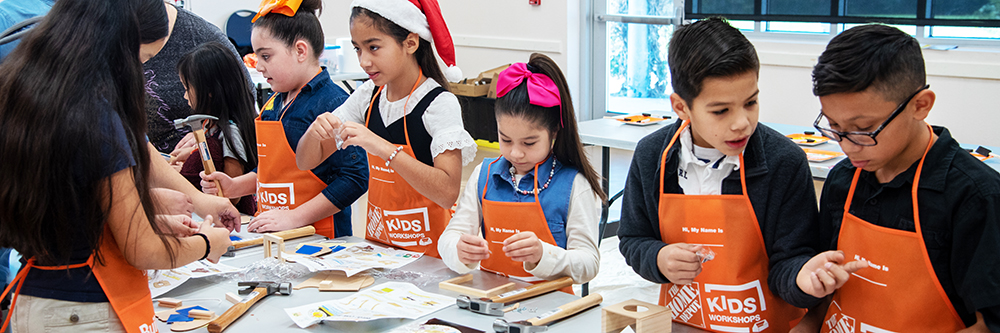 Kids at a community event putting together a kit from home depot.