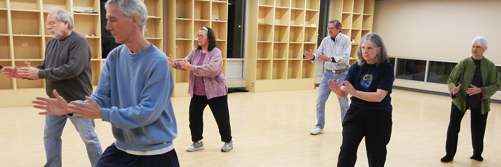 Seniors taking a yoga class.