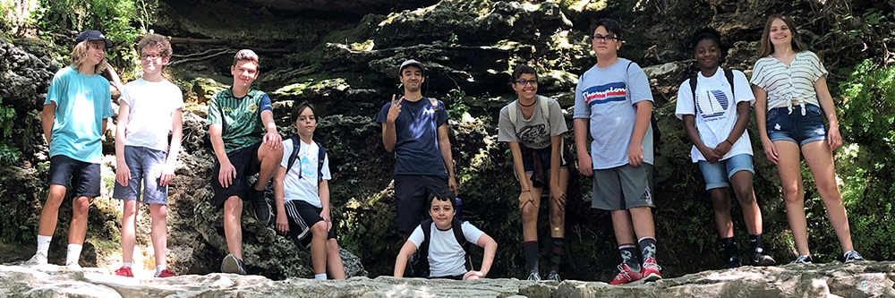 Teens posing for a picture after a hike.