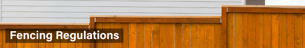 Wooden step down fence alongside a house