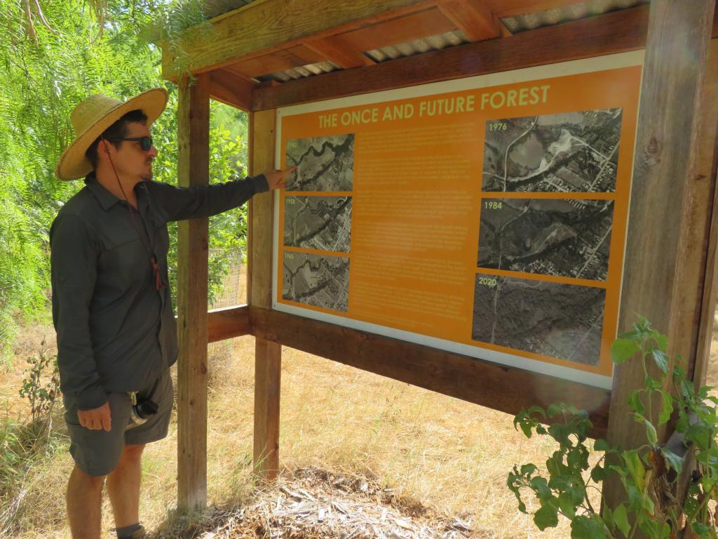 Ecology Action's Eric Paulus demonstrating an educational sign in Circle Acres Nature Preserve