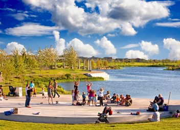 People beside a small lake in the Mueller Development in Austin, Texas