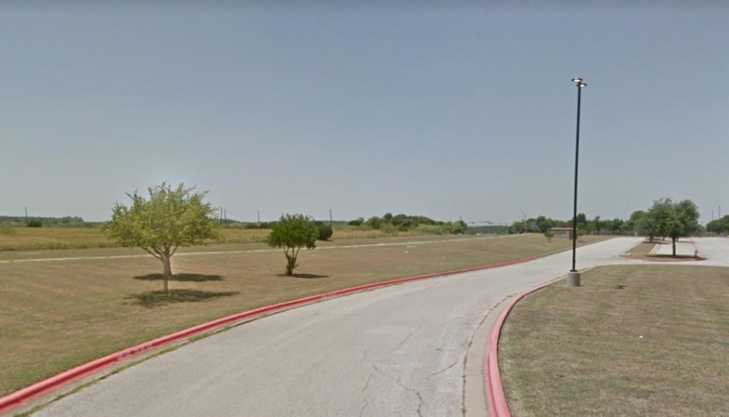 Photo from the grounds of Ojeda Middle School in Austin, Texas, with few trees and lots of pavement