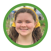 Keira, a teenage girl with long light brown hair, wearing gold hoop earrings and a yellow bandana