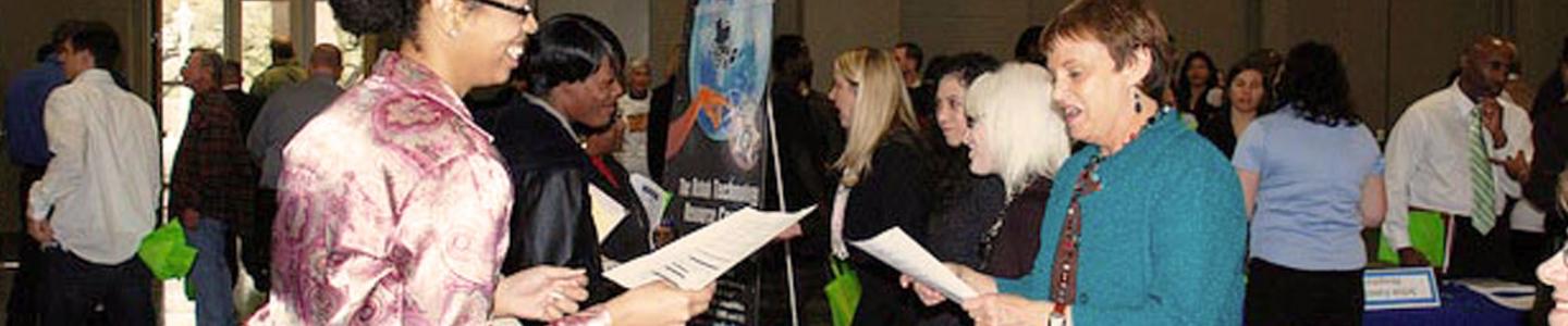 Crowd of people smiling at a convention