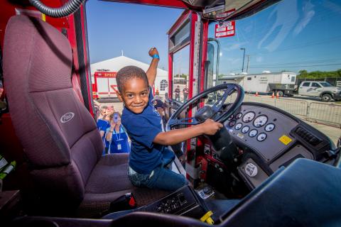 Child in fire truck