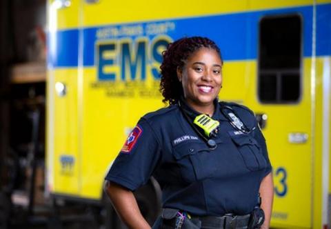 Female paramedic in front of an ambulance