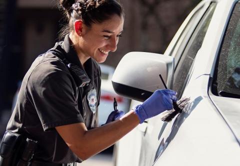 Forensic staff member taking fingerprints