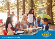 family of 6 people sitting at a picnic table outdoors at a campsite with smiles. The copy says Summer ready with Austin Code