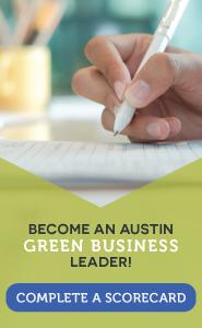 Photo of a hand holding a pen and completing paperwork. Text reads, "Become an Austin Green Business Leader. Complete a scorecard."