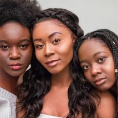 Three women with different natural hair styles 
