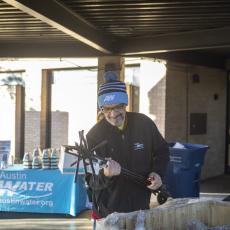 An Austin Water Utility employee sorting water meter keys before distributing them to customers.