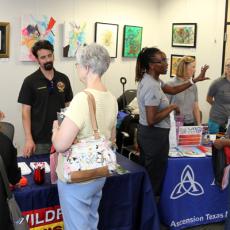 A photo showing community members visiting educational booths at an Emergency Preparedness Pop-up in a library.