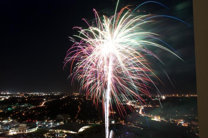 Image of fireworks bursting above city.