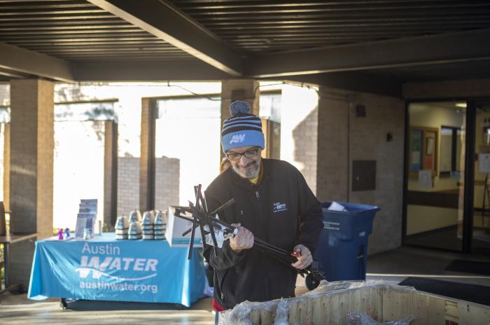 An Austin Water Utility employee sorting water meter keys before distributing them to customers.