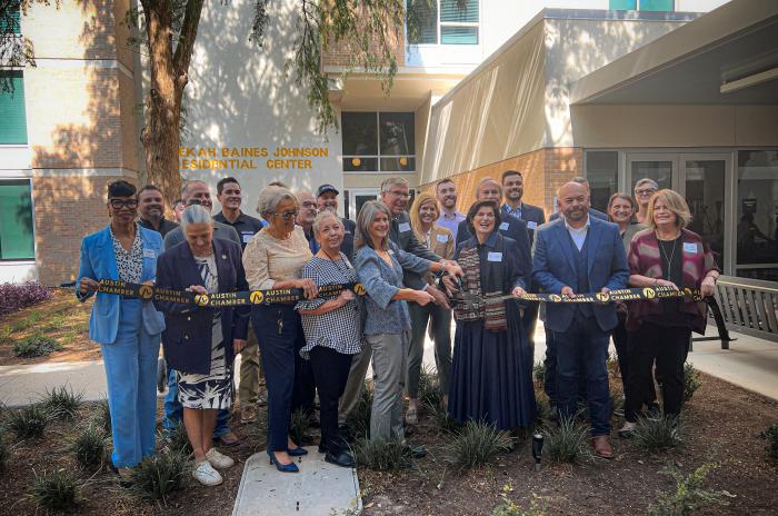 City and community leaders participate in a ribbon-cutting ceremony at the Rebekah Baines Johnson Residential Center grand reopening.