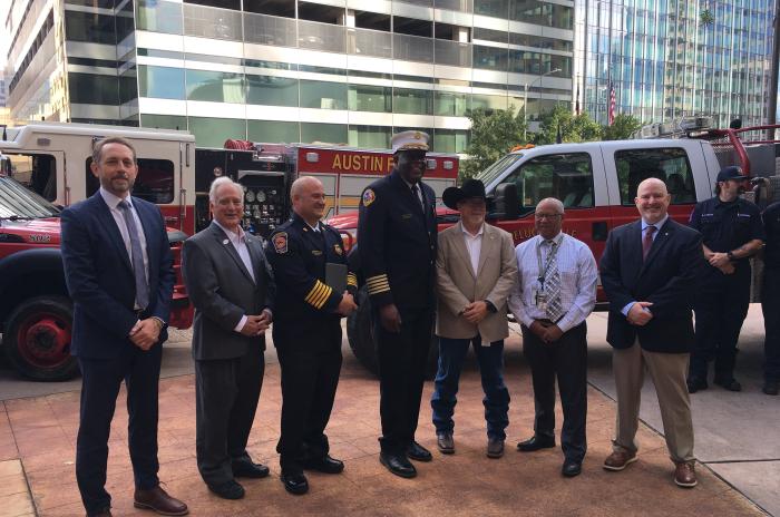 Group of city and county officials stand together for a photo following a press conference about wildfire threat and preparedness.