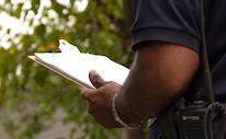 Code inspector holds a clipboard outdoors